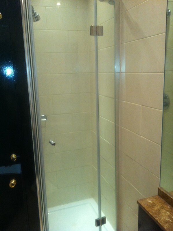 Frameless glass shower enclosure with chrome fittings in Crystal Palace