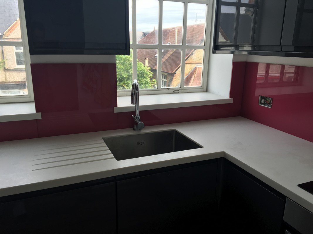 Deep plum coloured glass splashback in modern Crystal Palace kitchen